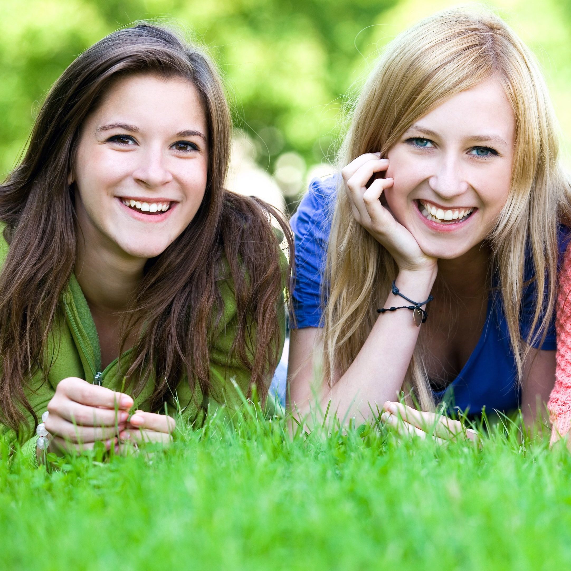 Three girls lying on the grass Three girls lying on the grass